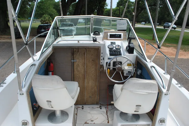 Slide: The Image of 1988 Grady-White Overnighter 20 boat interior with steering wheel and dashboard controls. - 6
