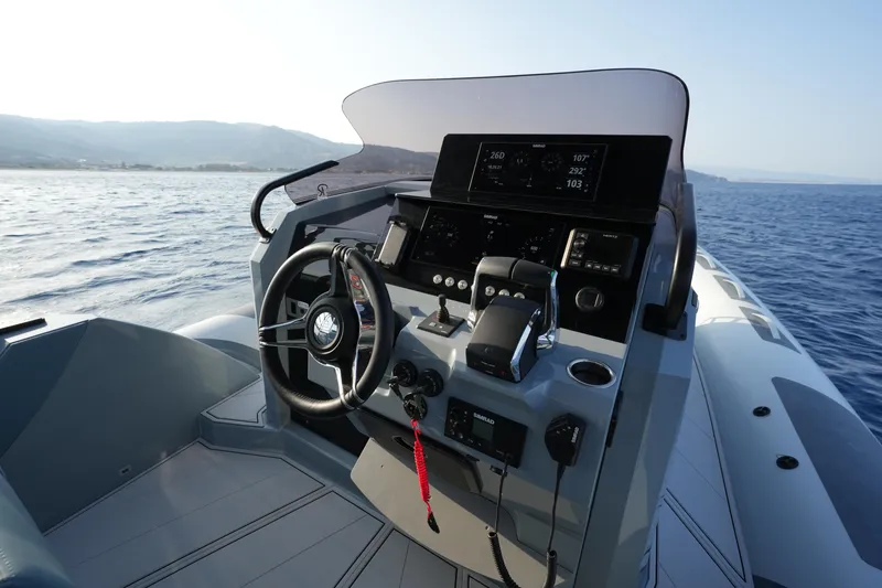 Slide: The Image of 2025 Ranieri Cayman 33 Executive boat dashboard on open water. - 14