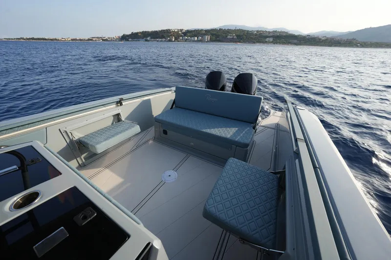 Slide: The Image of 2025 Ranieri Cayman 33 Executive boat interior on open water. - 15