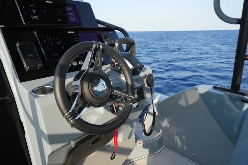 Slide: The Image of 2025 Ranieri Cayman 33 Executive boat steering console with ocean view. - 21