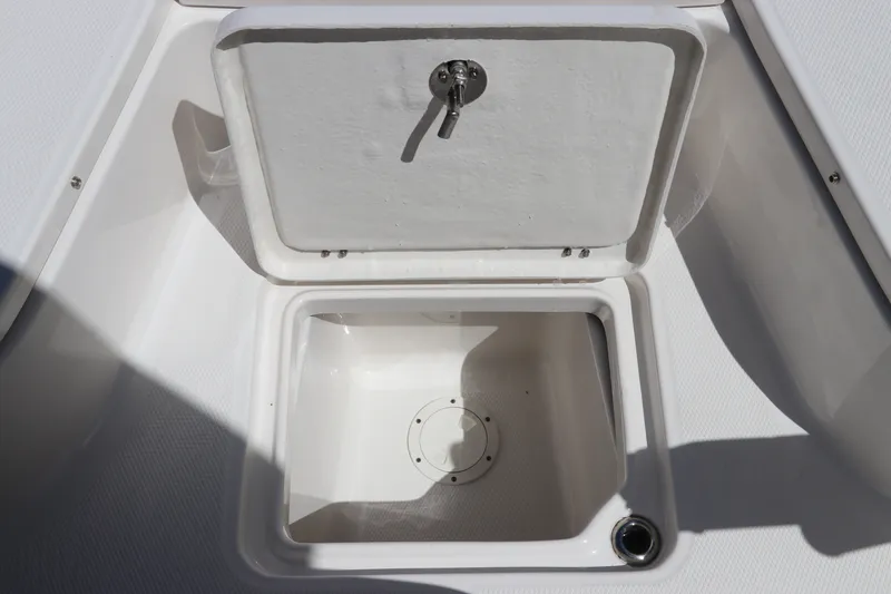 Slide: The Image of Open storage compartment on 2027 Robalo 226 Cayman boat. - 27