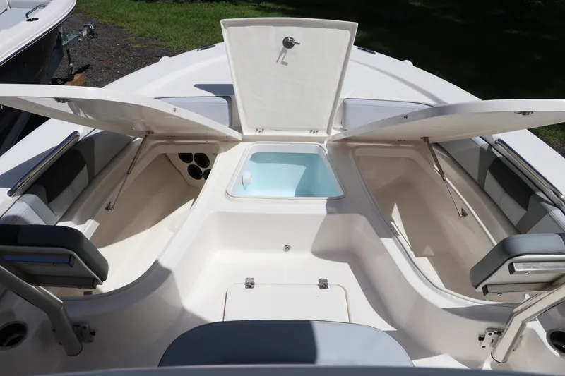 Slide: The Image of 2027 Robalo 226 Cayman boat interior with open storage compartments and seating. - 25