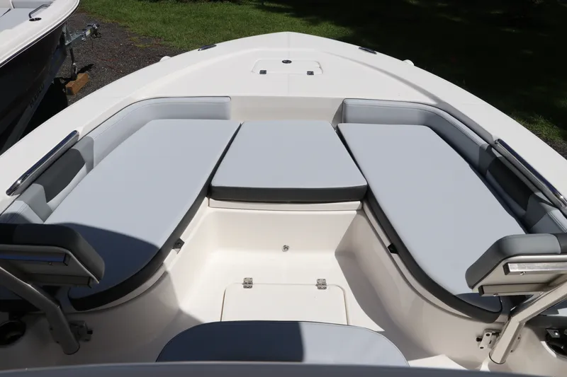 Slide: The Image of 2027 Robalo 226 Cayman boat interior with cushioned seating and storage compartments. - 23