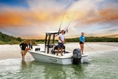Slide: The Image of 2027 Robalo 226 Cayman boat with people fishing near a scenic shoreline. - 10