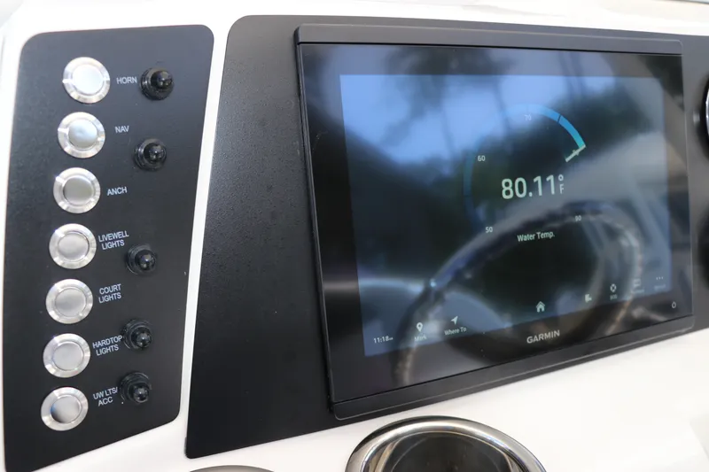 Slide: The Image of 2027 Robalo 226 Cayman dashboard with Garmin display and control buttons. - 17