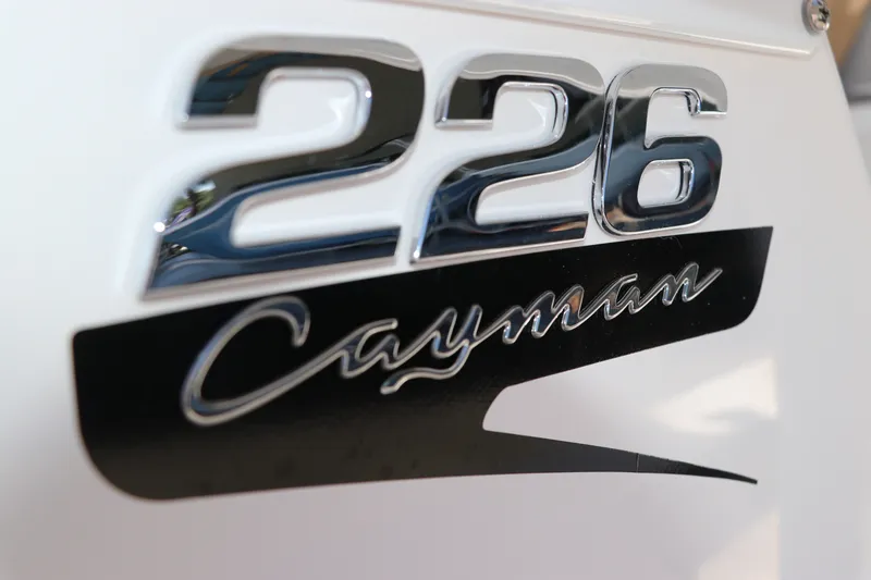 Slide: The Image of Close-up of 2027 Robalo 226 Cayman logo on boat exterior. - 30