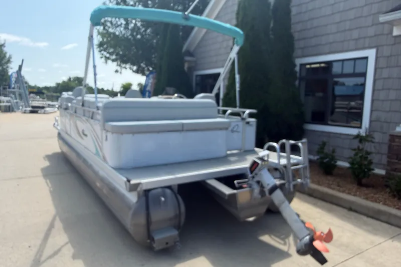 Slide: The Image of 2020 Quest Edge 820 pontoon boat parked outside a building on a sunny day. - 12