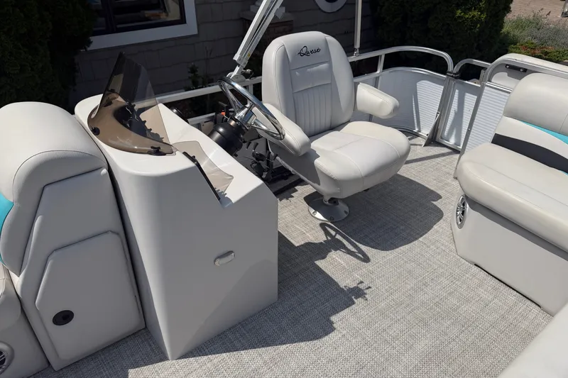 Slide: The Image of Pontoon boat interior with Quest Edge 820 helm, featuring white seating and steering console. - 8