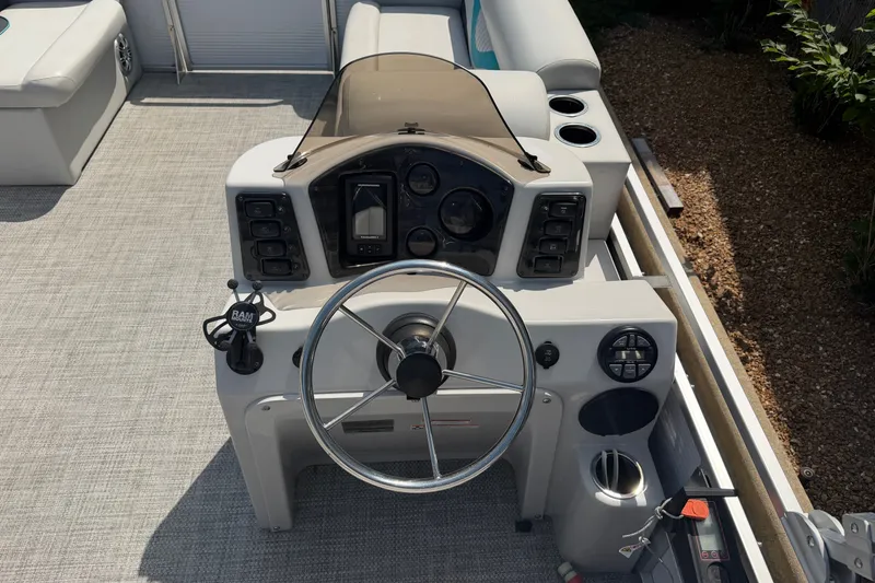 Slide: The Image of Cockpit of a 2020 Quest Edge 820 boat with steering wheel and control panel. - 9