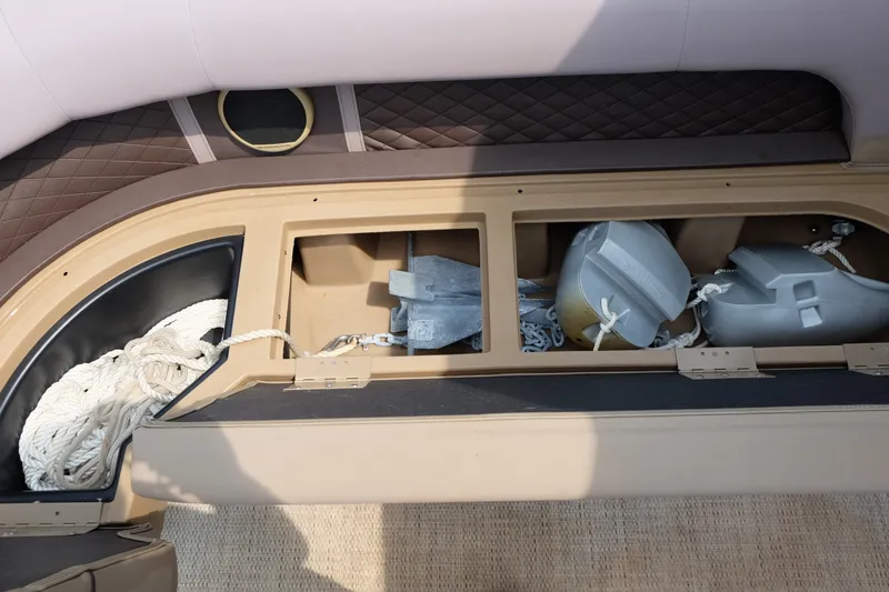 Slide: The Image of Storage compartment of a 2018 Bennington 21 SLXP boat with ropes and anchors. - 7