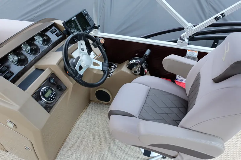 Slide: The Image of 2018 Bennington 21 SLXP boat helm with steering wheel and captain's chair. - 10