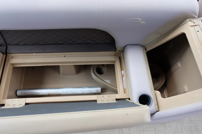 Slide: The Image of 2018 Bennington 21 SLXP boat interior storage compartments and cup holder. - 15