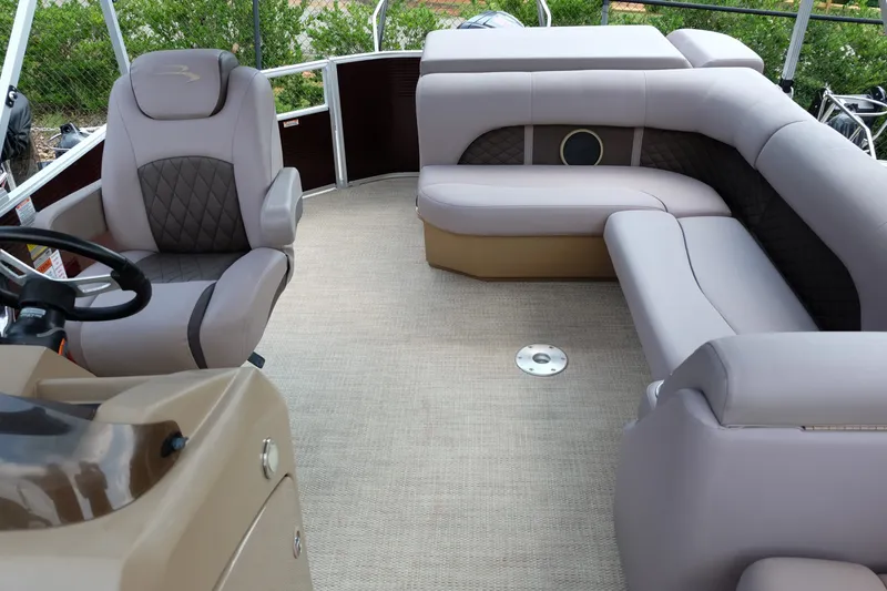 Slide: The Image of 2018 Bennington 21 SLXP pontoon boat interior with plush seating and steering console. - 9