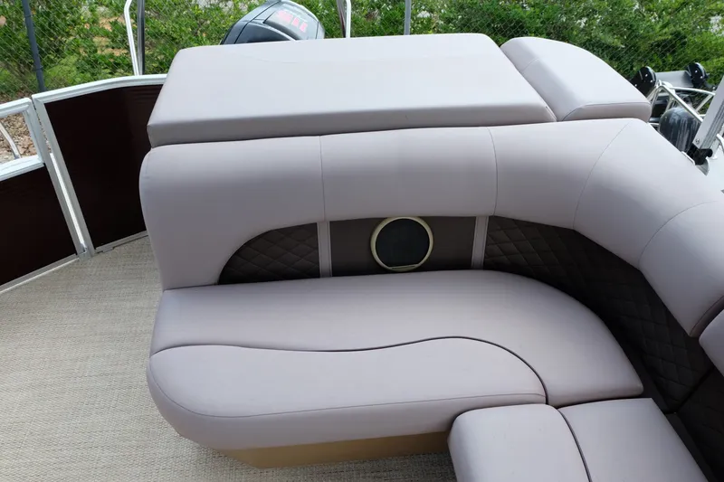 Slide: The Image of 2018 Bennington 21 SLXP boat interior with plush seating and speaker detail. - 16