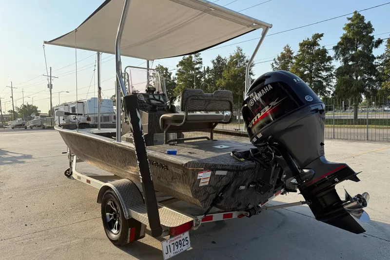 Slide: The Image of 2024 Xpress H190B Bay boat with Yamaha motor on trailer, parked outdoors. - 10