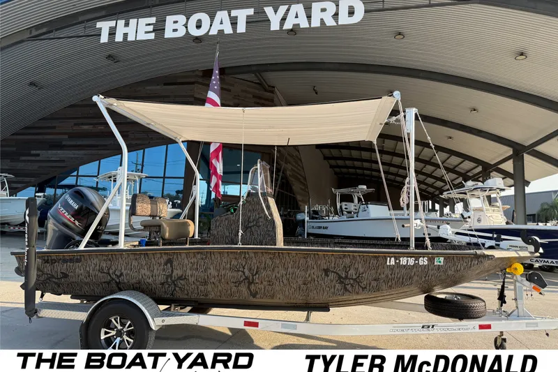 The Image of 2024 Xpress H190B Bay boat at The Boat Yard dealership, featuring a canopy and Yamaha motor. - 1