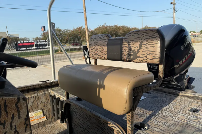 Slide: The Image of 2024 Xpress H190B Bay boat with Yamaha 115 engine, featuring camo seating and steering. - 14