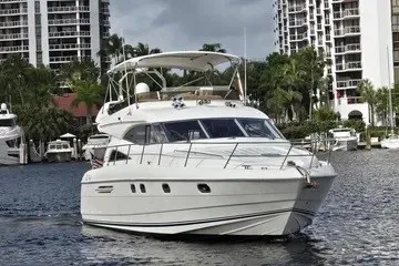 The Image of 1998 Viking Princess 56 Sport Cruiser yacht on water near urban buildings. - 1