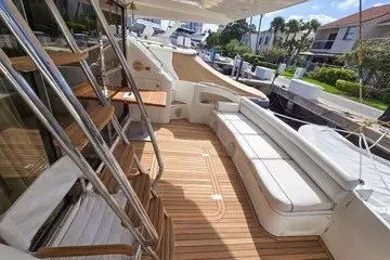 Slide: The Image of Spacious deck of 1998 Viking Princess 56 Sport Cruiser with elegant seating and wooden flooring. - 17