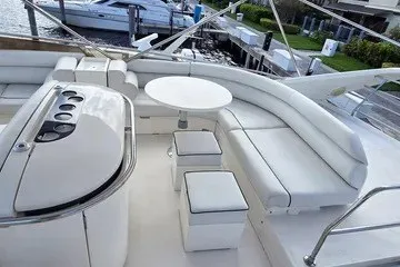 Slide: The Image of 1998 Viking Princess 56 Sport Cruiser with elegant white seating and dining area on deck. - 16