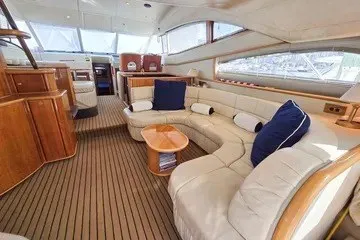 Slide: The Image of Luxurious interior of 1998 Viking Princess 56 Sport Cruiser with elegant seating and wooden accents. - 29