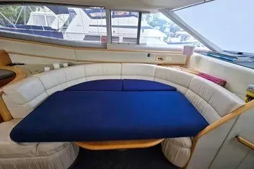 Slide: The Image of Interior of 1998 Viking Princess 56 Sport Cruiser with curved seating and blue cushions. - 35
