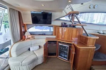 Slide: The Image of Luxurious interior of 1998 Viking Princess 56 Sport Cruiser yacht with elegant seating and entertainment area. - 23