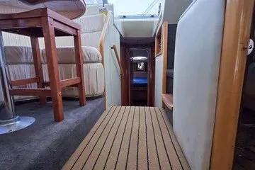 Slide: The Image of Interior view of 1998 Viking Princess 56 Sport Cruiser, featuring a cozy hallway and seating area. - 31