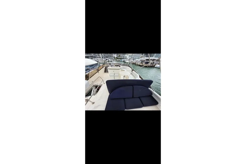 Slide: The Image of 1998 Viking Princess 56 Sport Cruiser yacht with spacious deck and seating area. - 37