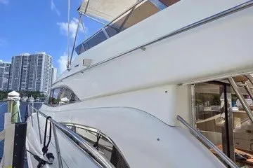 Slide: The Image of 1998 Viking Princess 56 Sport Cruiser docked with city skyline in background. - 7