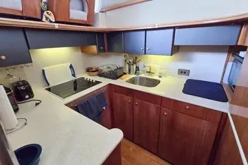 Slide: The Image of 1998 Viking Princess 56 Sport Cruiser kitchen with modern appliances and wooden cabinetry. - 25