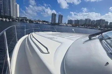 Slide: The Image of 1998 Viking Princess 56 Sport Cruiser on water with city skyline in background. - 4