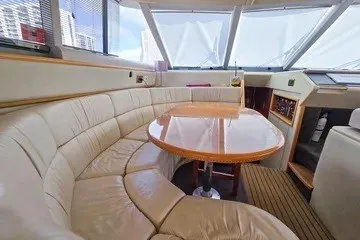 Slide: The Image of Luxurious interior of a 1998 Viking Princess 56 Sport Cruiser with plush seating and wooden table. - 30