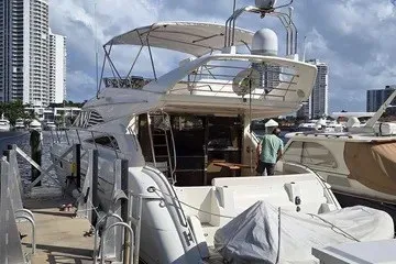 Slide: The Image of 1998 Viking Princess 56 Sport Cruiser docked at marina with city skyline. - 21