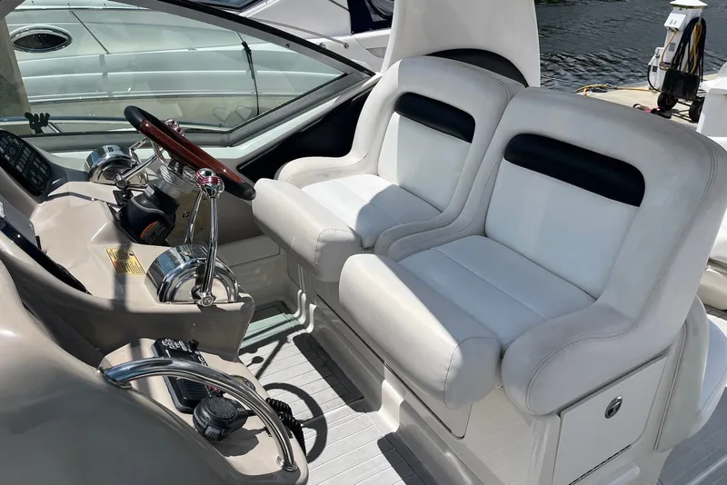 Slide: The Image of Cockpit of 2003 Sea Ray Sundancer 320 with dual white seats and control panel. - 4