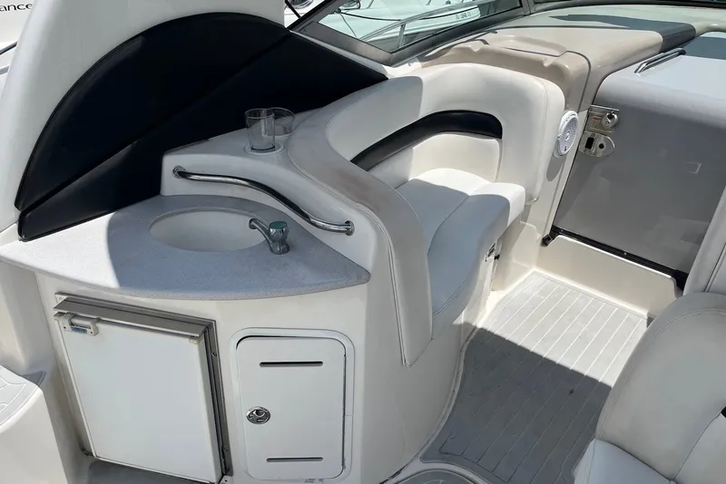 Slide: The Image of 2003 Sea Ray Sundancer 320 interior with sink, seating, and storage. - 6