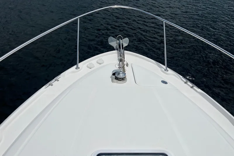Slide: The Image of Bow of 2003 Sea Ray Sundancer 320 yacht on calm water. - 2
