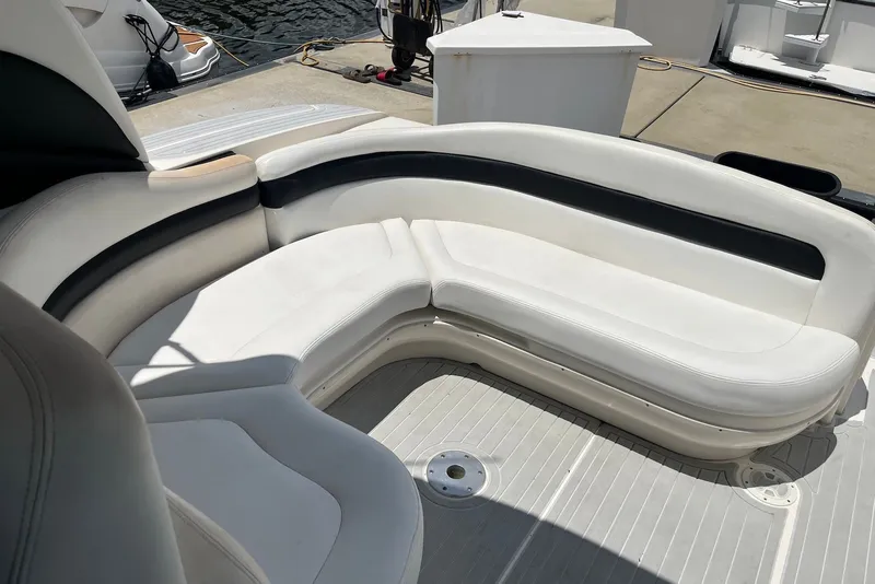Slide: The Image of White leather seating on a 2003 Sea Ray Sundancer 320 boat, docked at marina. - 3