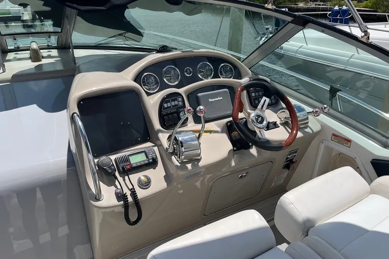 Slide: The Image of 2003 Sea Ray Sundancer 320 helm with steering wheel and navigation controls. - 5