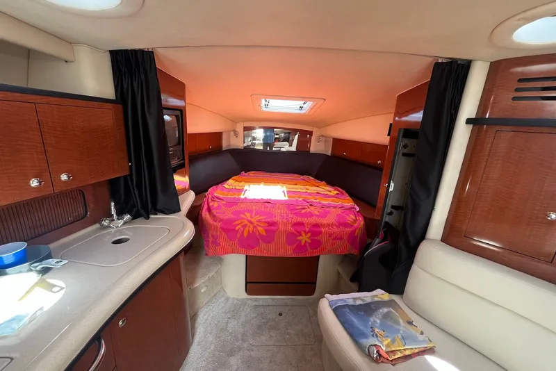 Slide: The Image of Interior of 2003 Sea Ray Sundancer 320 with cozy cabin and vibrant bedding. - 10