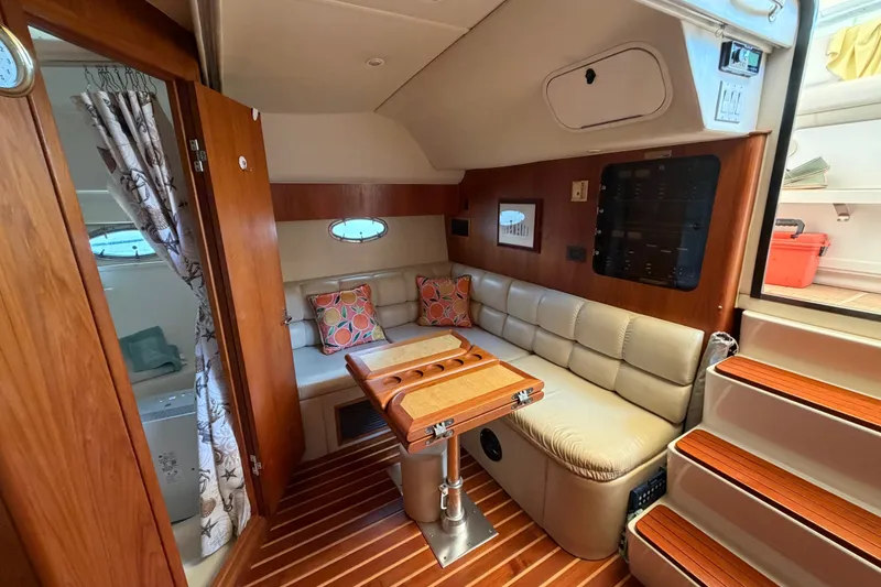Slide: The Image of Luxurious interior of 2001 Tiara 35 Express yacht with plush seating and wooden accents. - 15