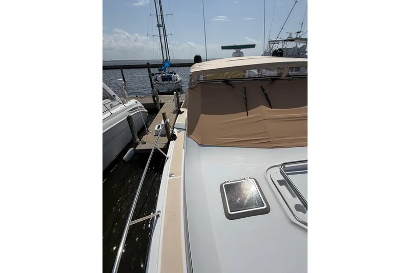Slide: The Image of 2001 Tiara 35 Express yacht docked at marina under clear sky. - 6
