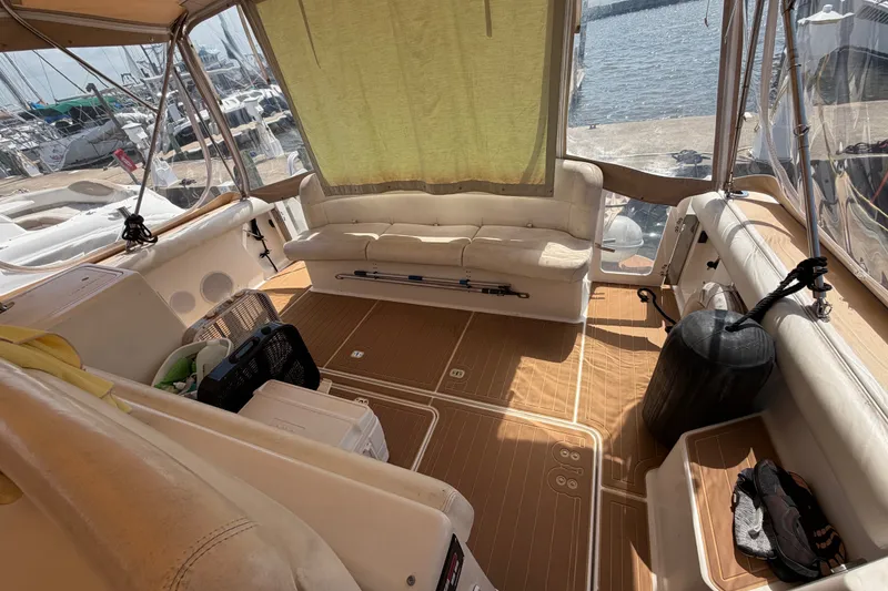 Slide: The Image of Interior view of a 2001 Tiara 35 Express yacht with seating and dockside view. - 3