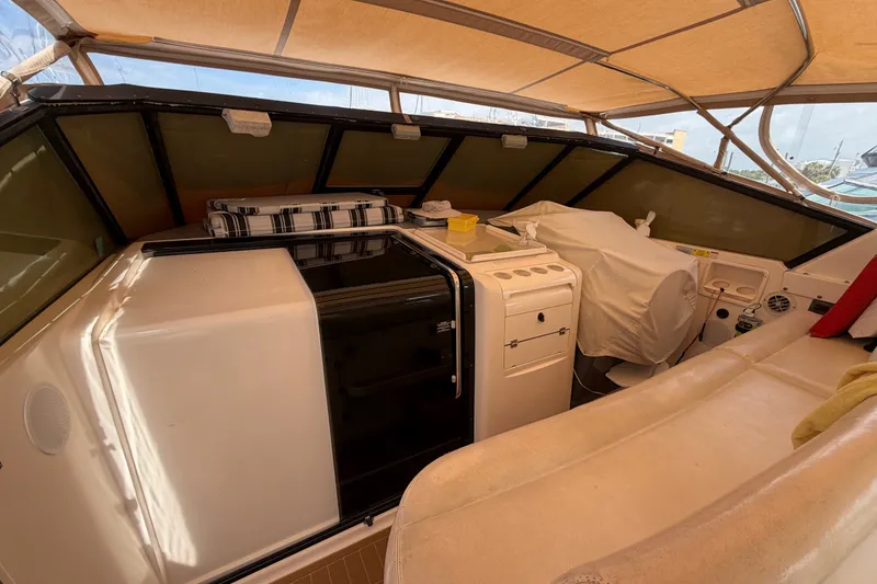 Slide: The Image of Interior view of a 2001 Tiara 35 Express boat with covered seating and helm. - 21
