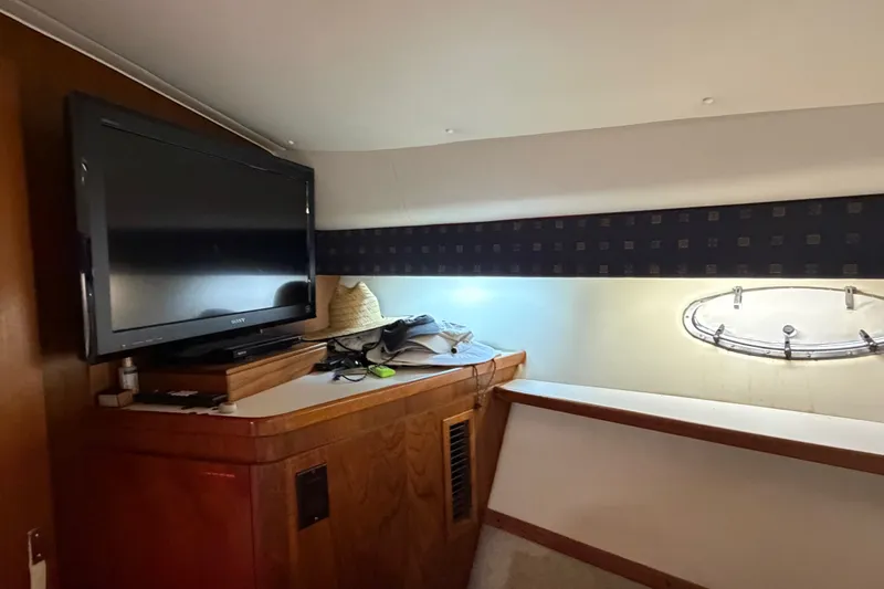 Slide: The Image of Interior of 2001 Tiara 35 Express yacht with TV and porthole window. - 19
