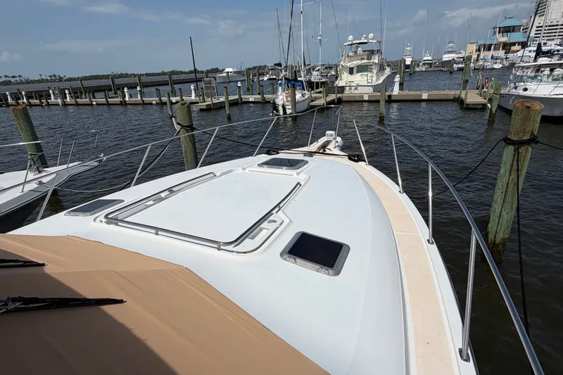 Slide: The Image of 2001 Tiara 35 Express yacht docked at marina, showcasing sleek deck design and waterfront view. - 9