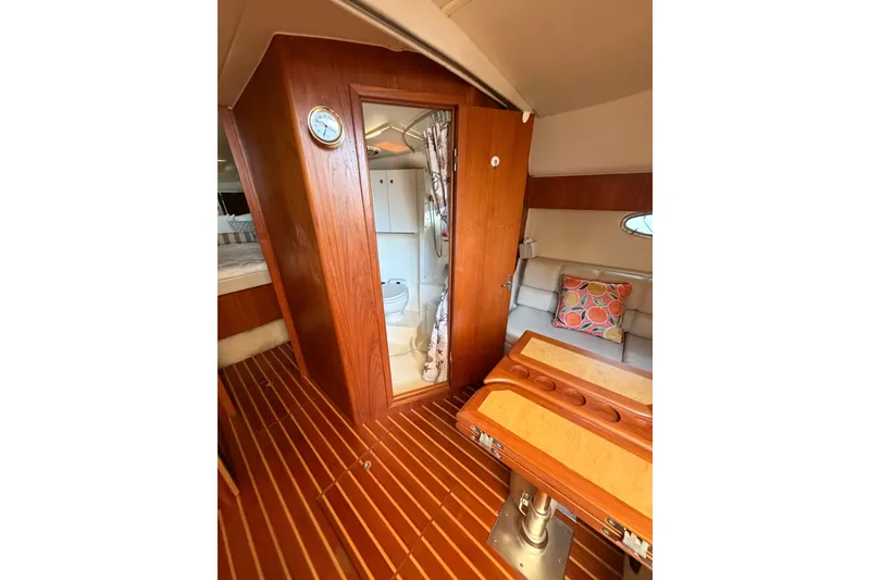Slide: The Image of Interior of 2001 Tiara 35 Express yacht with wooden flooring and cozy seating area. - 14
