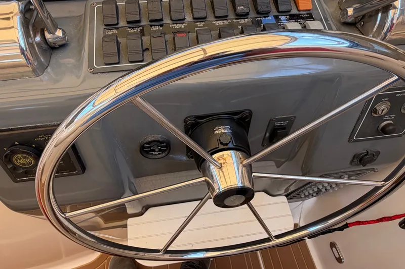 Slide: The Image of Steering wheel and control panel of a 2001 Tiara 35 Express boat. - 4