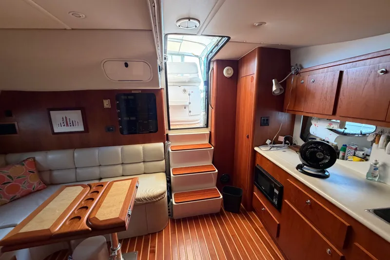 Slide: The Image of Interior of a 2001 Tiara 35 Express yacht with wooden cabinetry and seating area. - 11