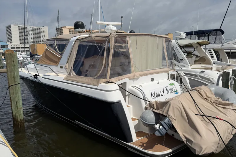 Slide: The Image of 2001 Tiara 35 Express yacht docked at marina, featuring covered deck and sleek design. - 23